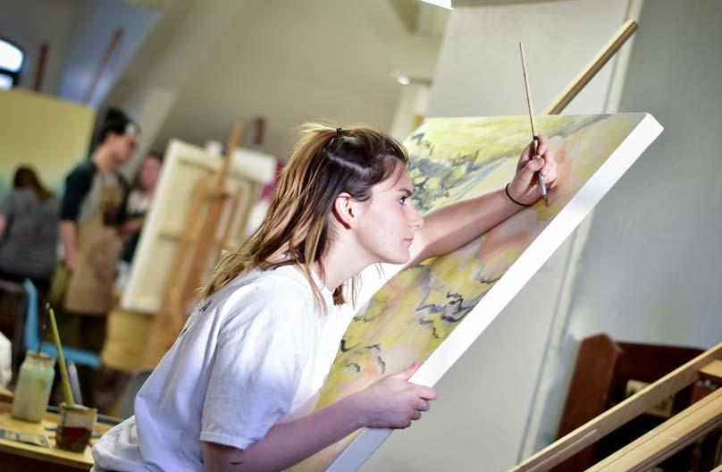 A student at a canvas in painting class